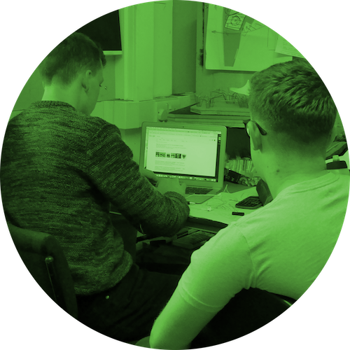 Researcher observing student working at desk 