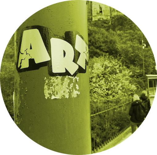 Art sticker on lamp post with students sketching in background